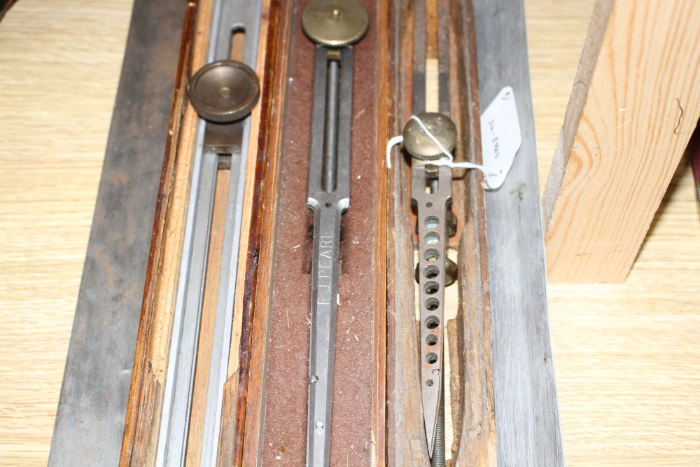 Three wooden cased technical draughtsman tools, stamped for the owner FJ Pearl, largest 77cm